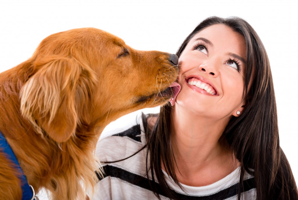 Dog kissing a woman