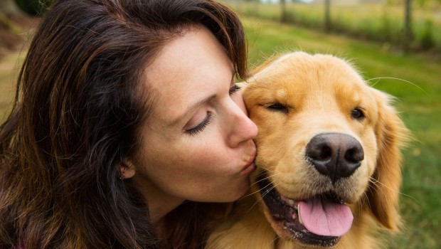 woman kissing her dog