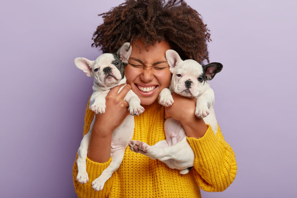 Woman holding two puppies